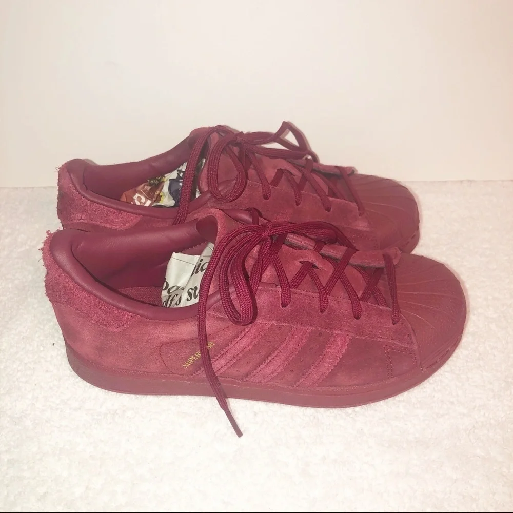 Adidas superstar suede burgundy shell toe sneaker.
